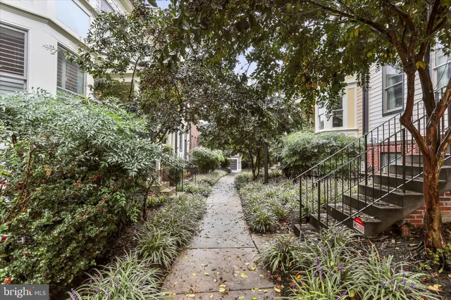 a bathroom with a granite countertop toilet sink and mirror