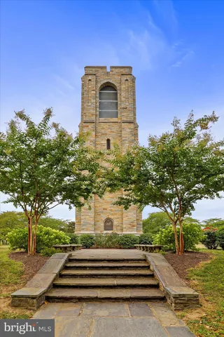 a view of a lake with a yard and large trees