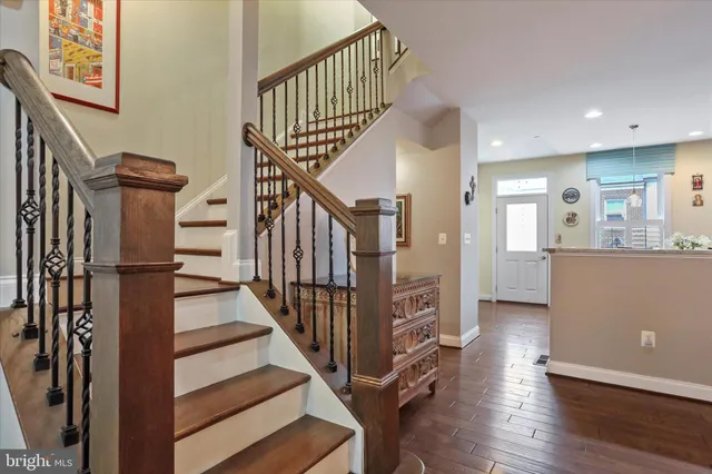 a view of a hallway with wooden floor and staircase