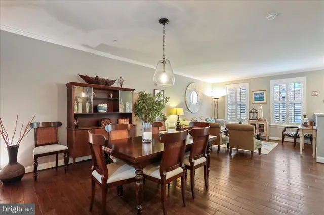 a dining room with furniture and wooden floor