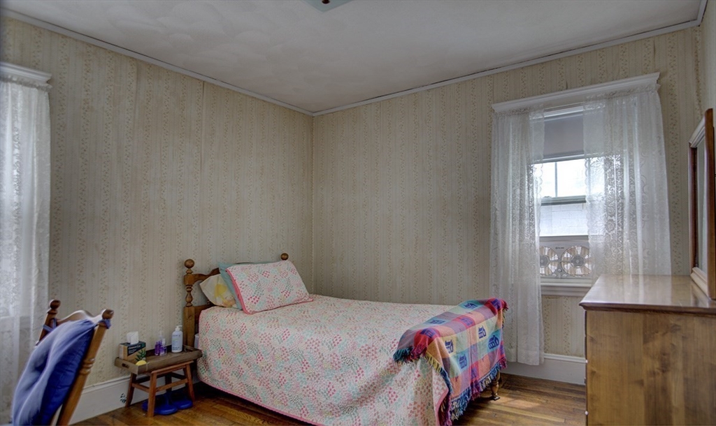 44 Cottage Park Road Winthrop, MA 02152 - Photo 12 of 39 a bedroom with a bed and wooden floor