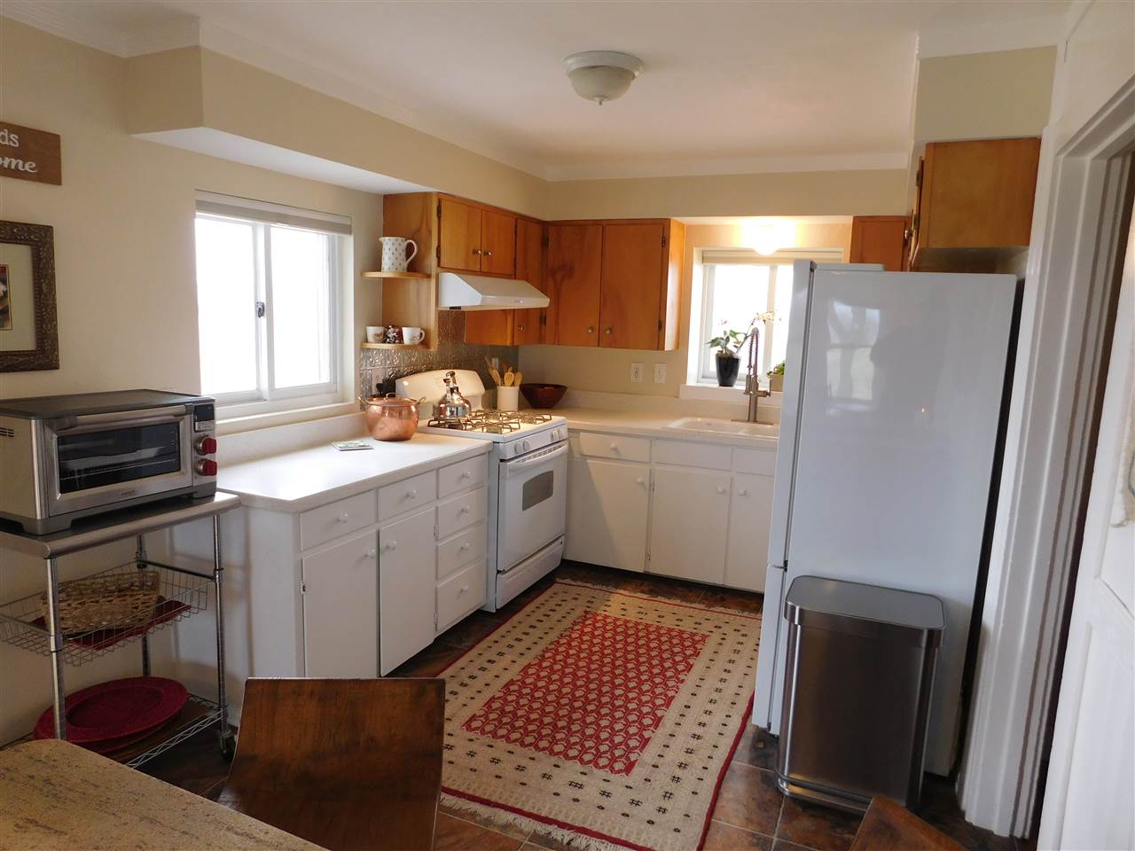 1640 P Road Loma, CO 81524 - Photo 8 of 40 a kitchen with a refrigerator a stove a sink and a window