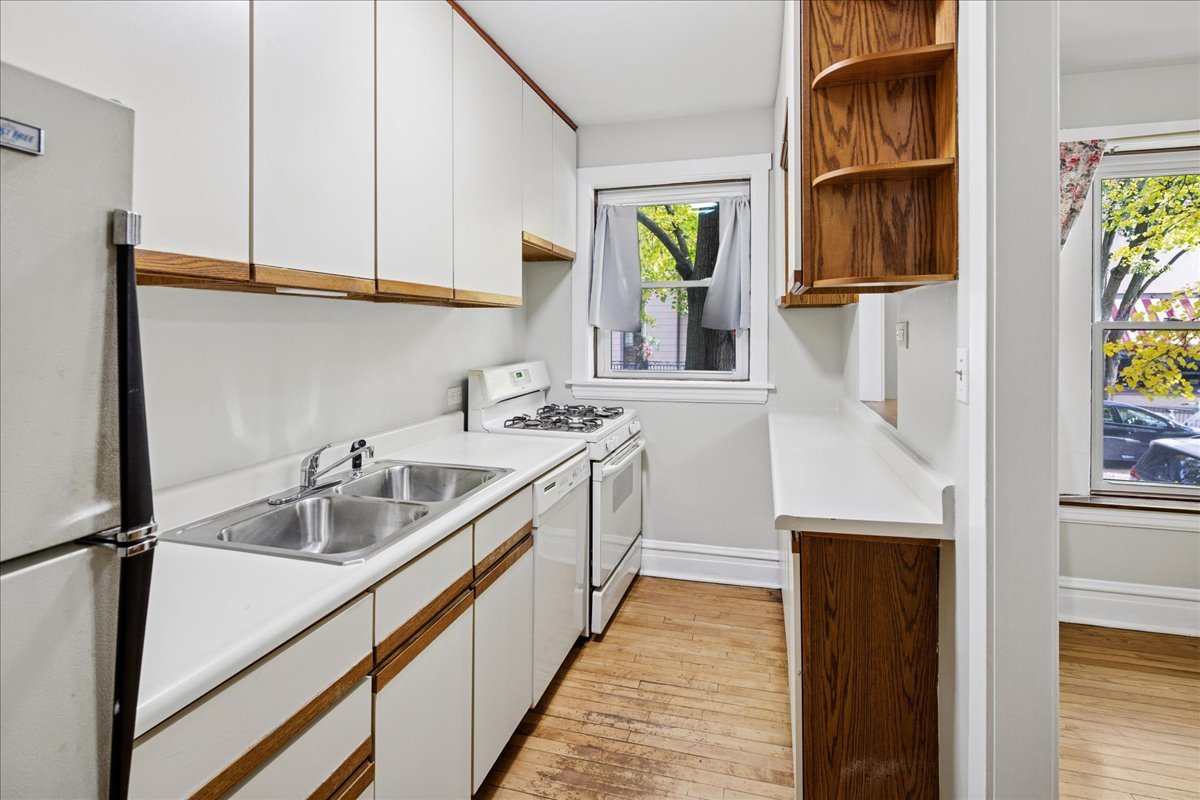 734 West Wrightwood Avenue, Unit B Chicago, IL 60614 - Photo 6 of 21 a kitchen with stainless steel appliances granite countertop a sink a stove and a refrigerator