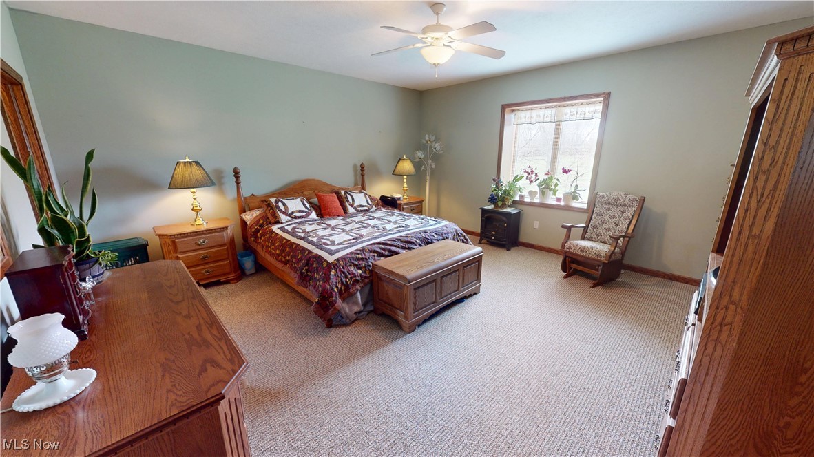 10323 Smith Road Litchfield, OH 44253 - Photo 19 of 50 Bedroom with baseboards, ceiling fan, and light carpet
