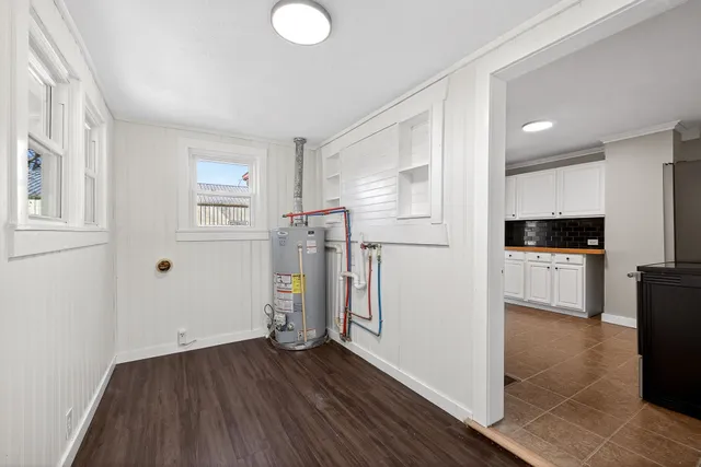 a view of empty room with wooden floor and electronic appliances