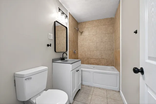 a bathroom with a toilet sink and shower