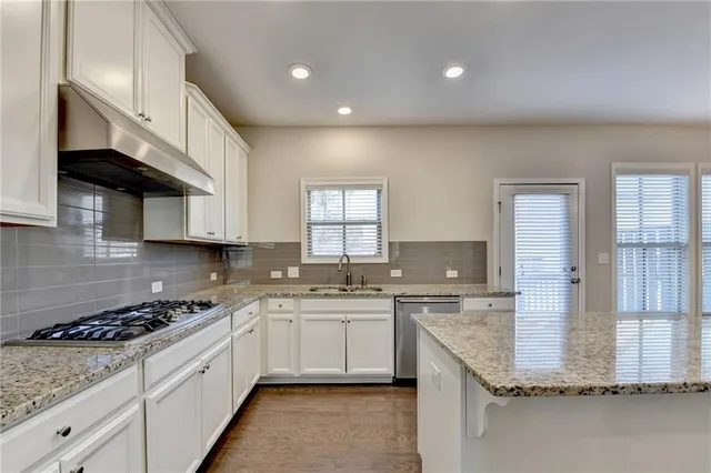 a kitchen with a sink stove and cabinets