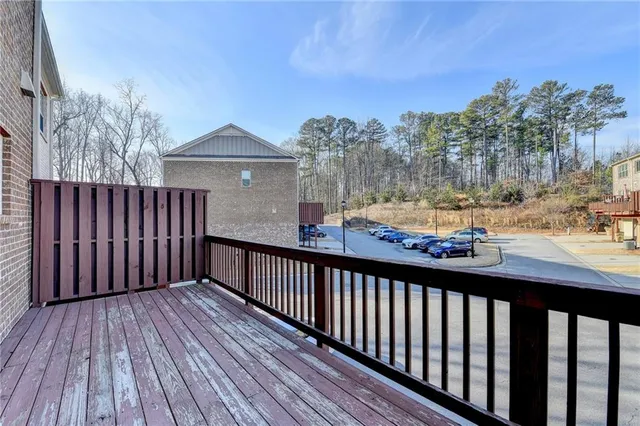 a view of a balcony with wooden floor and fence