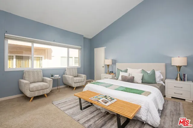 a bedroom with a bed and a couch