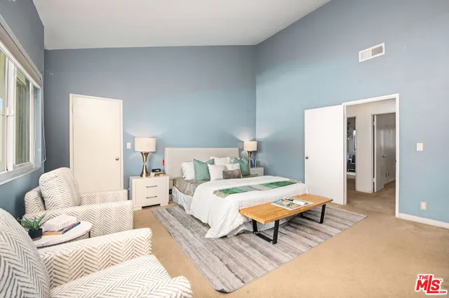 a living room with a bed furniture and a large window