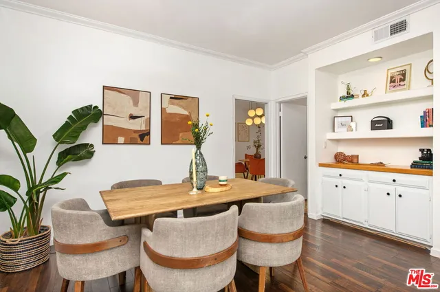 a dining room with furniture and wooden floor