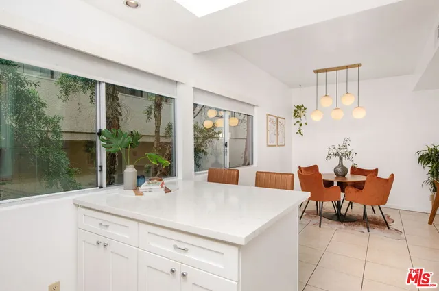 a view of a dining room with furniture a livingroom and chandelier