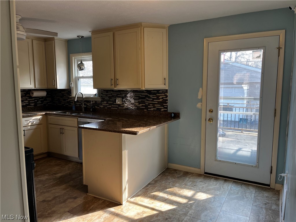 30824 Clarmont Road Willowick, OH 44095 - Photo 12 of 24 Kitchen with plenty of natural light, sink, backsplash, and light tile floors