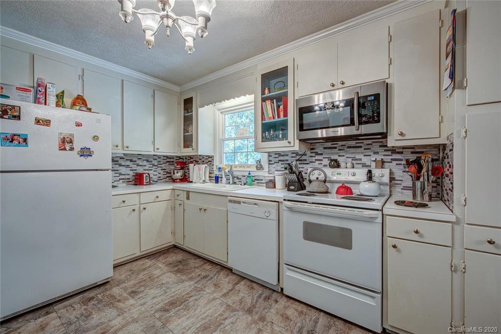 912 Parkwood Road Shelby, NC 28150 - Photo 12 of 23 a kitchen with stainless steel appliances white cabinets and a refrigerator