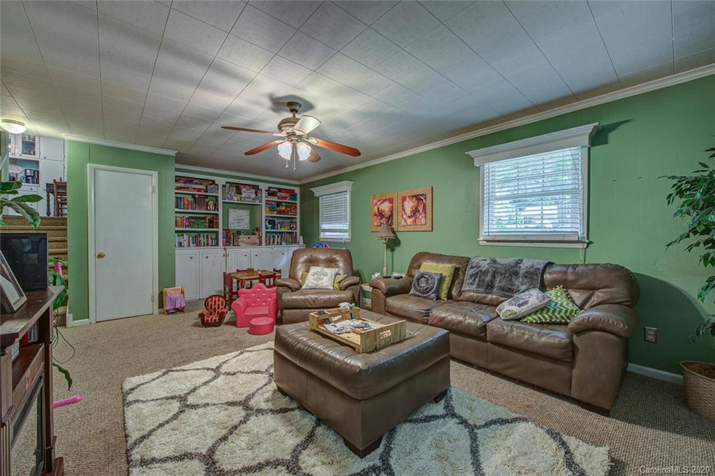 912 Parkwood Road Shelby, NC 28150 - Photo 13 of 23 a living room with furniture a chandelier and a window