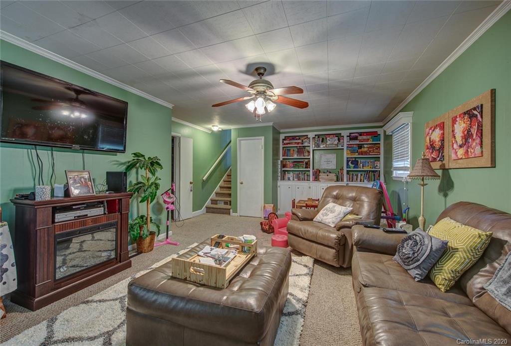 912 Parkwood Road Shelby, NC 28150 - Photo 14 of 23 a living room with furniture and a flat screen tv