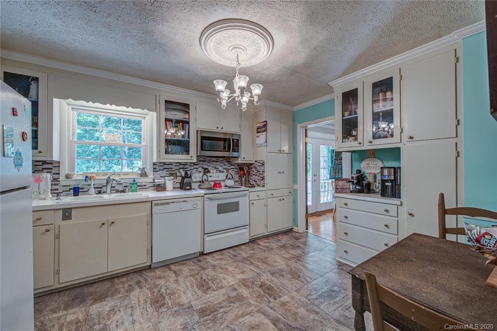 912 Parkwood Road Shelby, NC 28150 - Photo 9 of 23 a kitchen with a stove cabinets and window