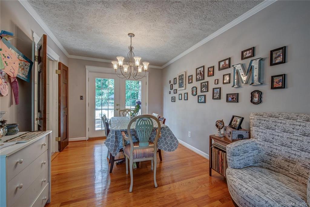 912 Parkwood Road Shelby, NC 28150 - Photo 10 of 23 a dining room with furniture a chandelier and wooden floor