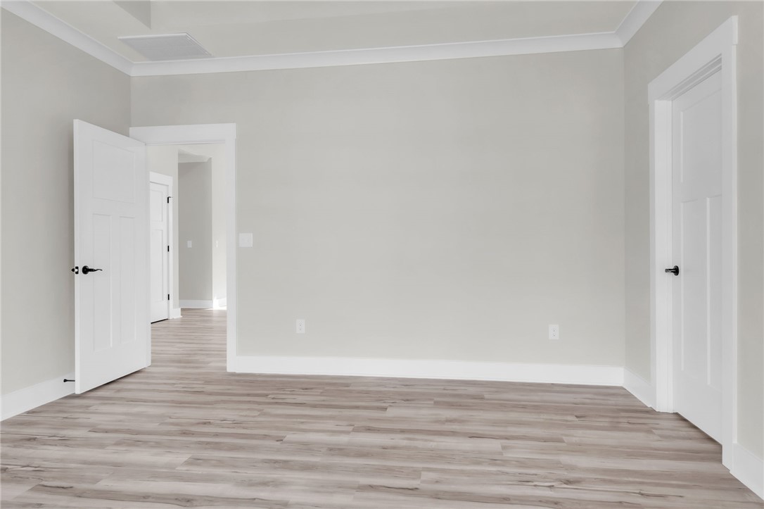 121 Ashley Drive Pelzer, SC 29669 - Photo 11 of 25 Unfurnished room featuring light wood finished floors and ornamental molding