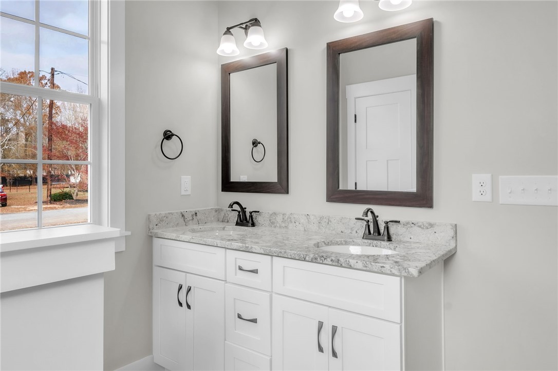 121 Ashley Drive Pelzer, SC 29669 - Photo 15 of 25 Full bathroom featuring double vanity and baseboards