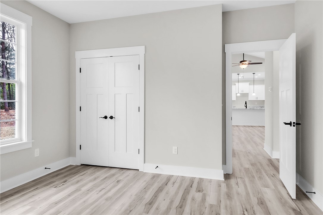 121 Ashley Drive Pelzer, SC 29669 - Photo 19 of 25 Unfurnished bedroom with light wood-type flooring and a closet