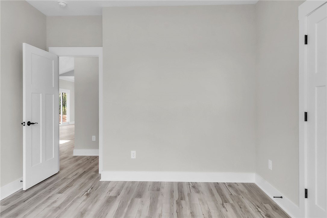121 Ashley Drive Pelzer, SC 29669 - Photo 22 of 25 Empty room with light wood finished floors and baseboards