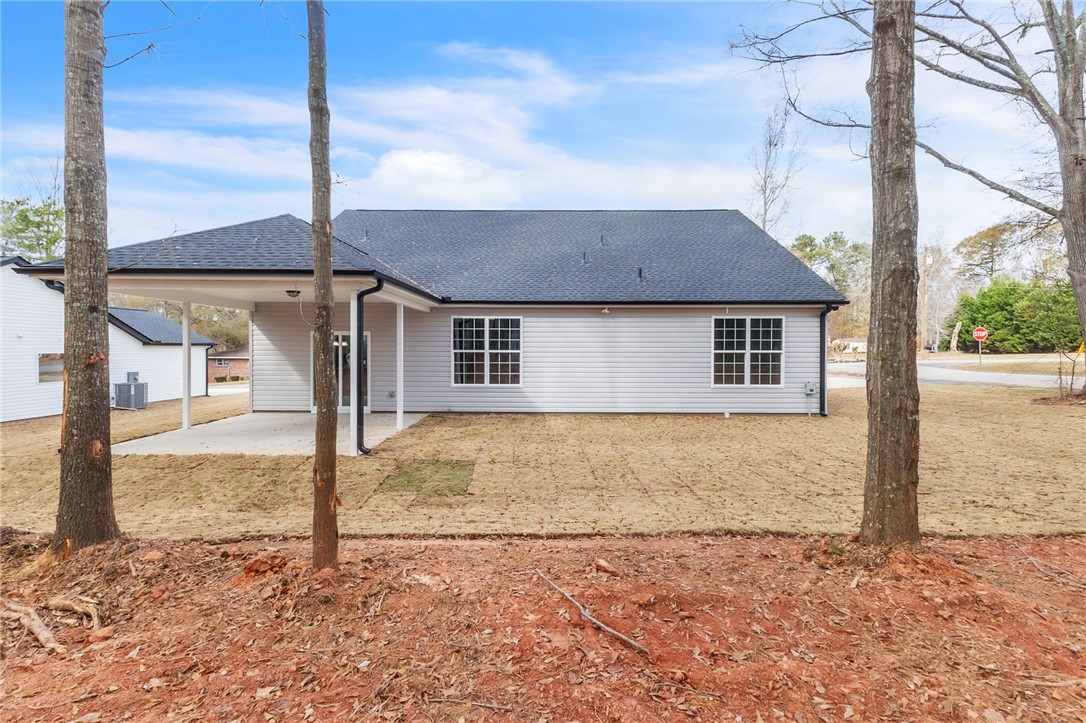 121 Ashley Drive Pelzer, SC 29669 - Photo 24 of 25 Rear view of house with a patio area and roof with shingles