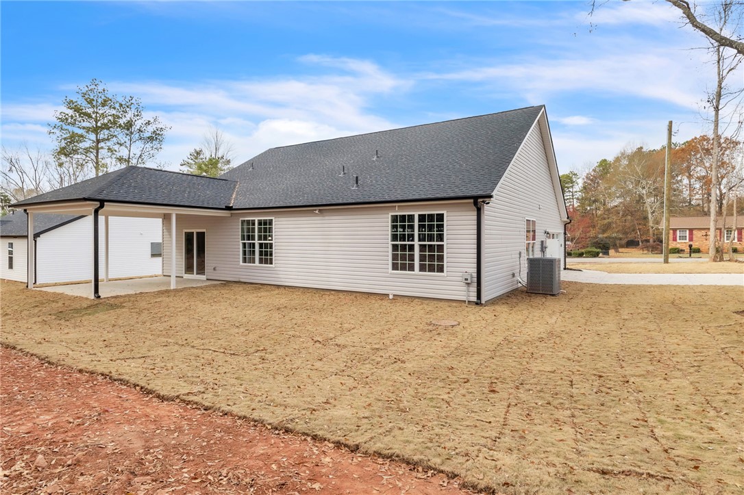 121 Ashley Drive Pelzer, SC 29669 - Photo 25 of 25 Back of property with a patio and roof with shingles