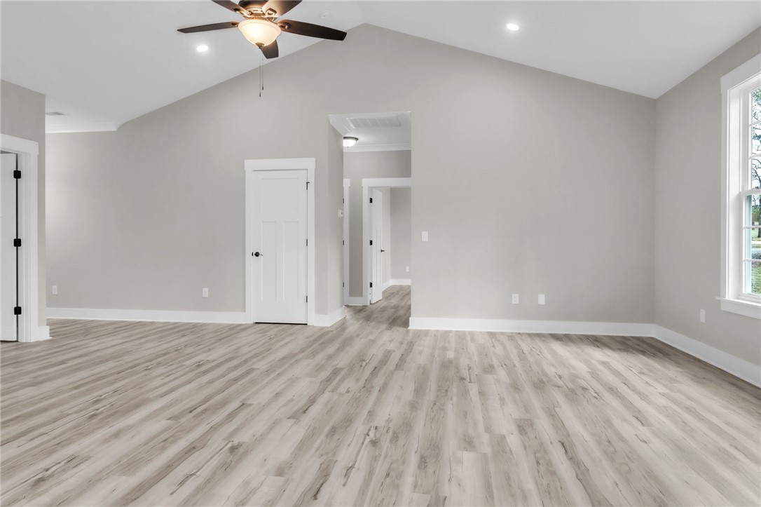 121 Ashley Drive Pelzer, SC 29669 - Photo 6 of 25 Unfurnished living room with light wood-style floors, ceiling fan, lofted ceiling, and recessed lighting