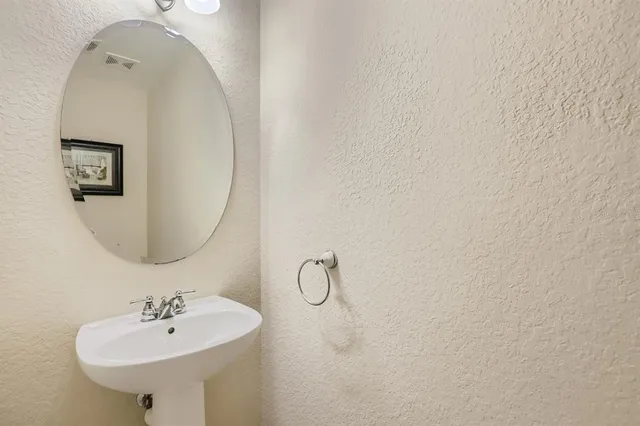 a kitchen with stainless steel appliances granite countertop a refrigerator a stove a sink and a microwave