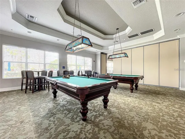 a room with furniture and pool table