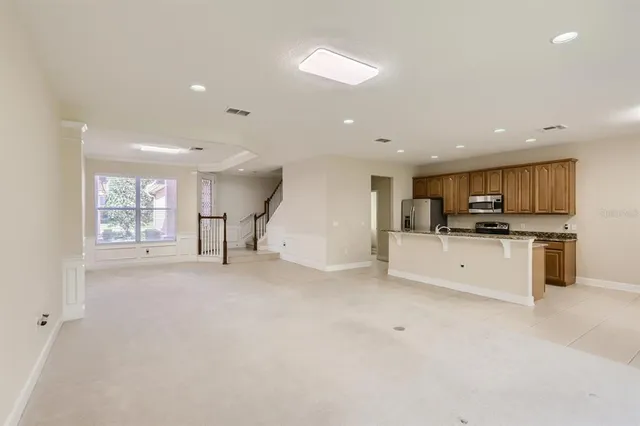 a view of kitchen with stainless steel appliances kitchen island sink and cabinets
