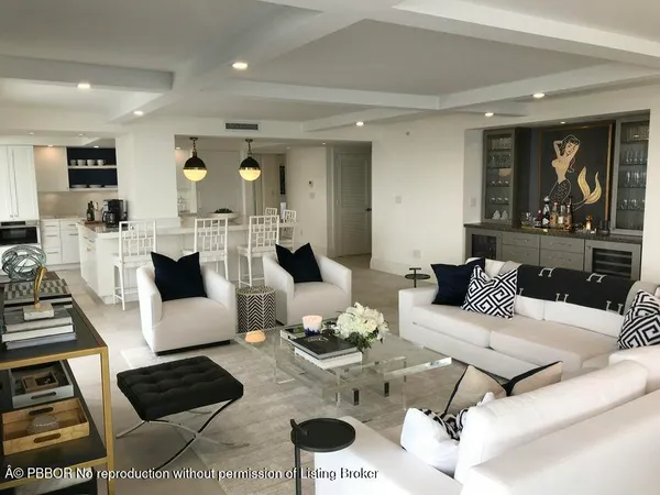 a living room with furniture a rug and a chandelier