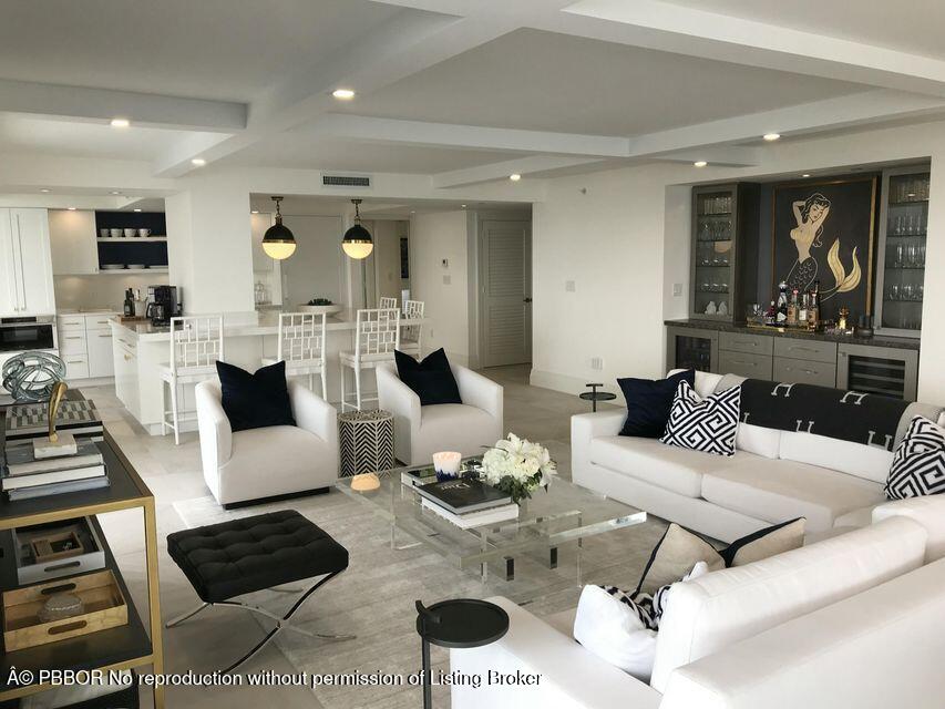 400 South Beach Road, Unit 504 Tequesta, FL 33469 - Photo 7 of 22 a living room with furniture a rug and a chandelier