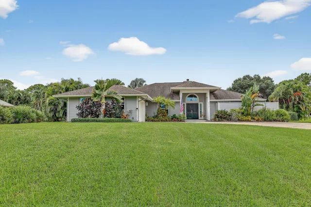 a front view of house with yard and outdoor seating