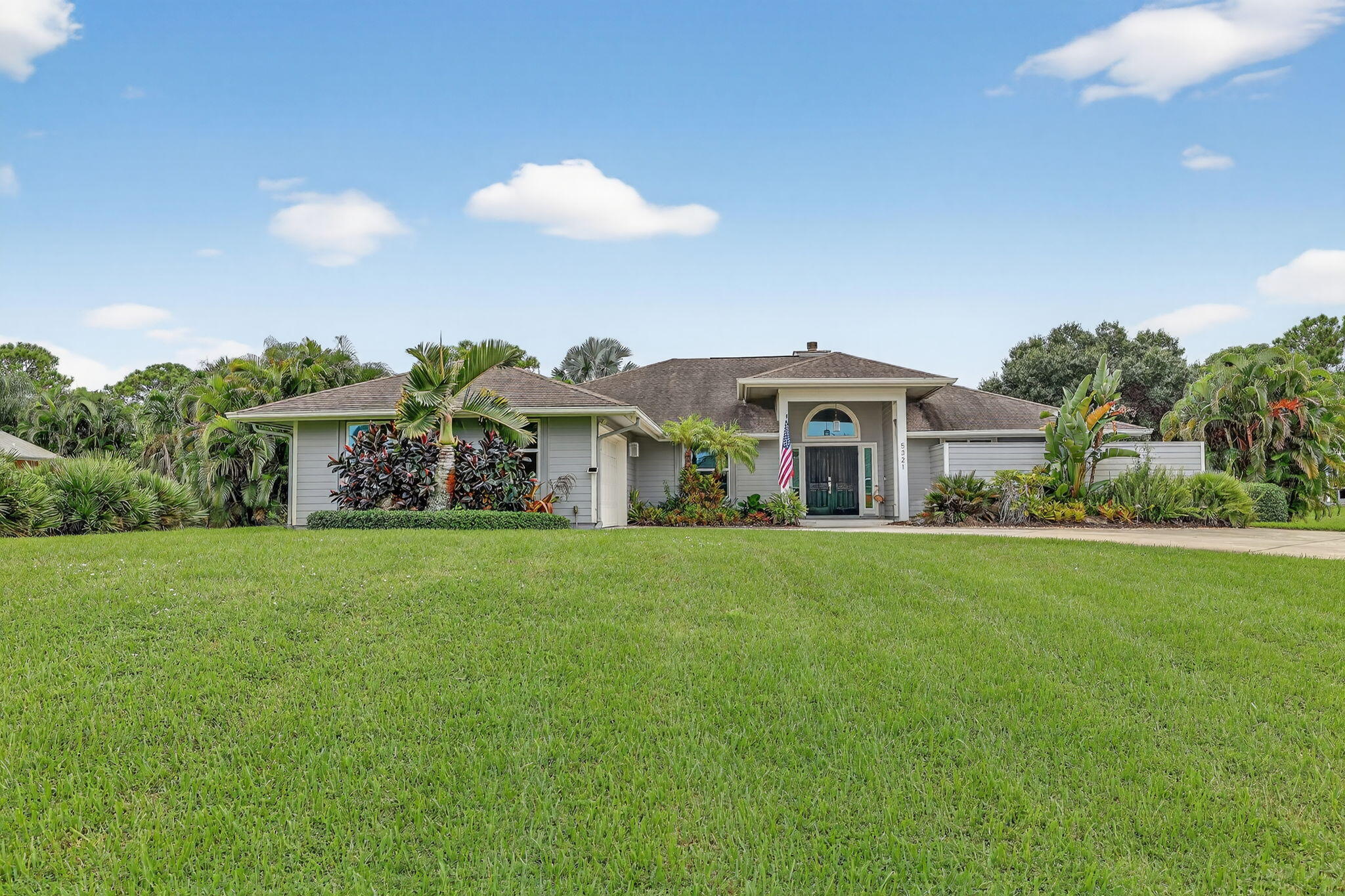 a front view of house with yard and outdoor seating