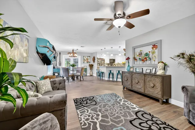 a living room with furniture and wooden floor