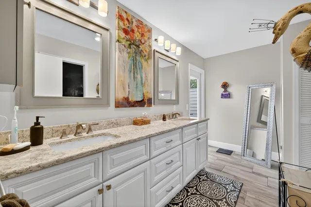 a view of a hallway with wooden floor and a bedroom