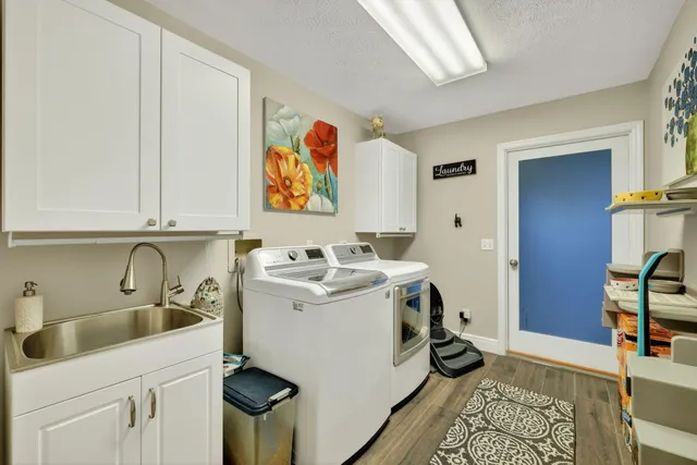 a living room with furniture a flat screen tv and a floor to ceiling window