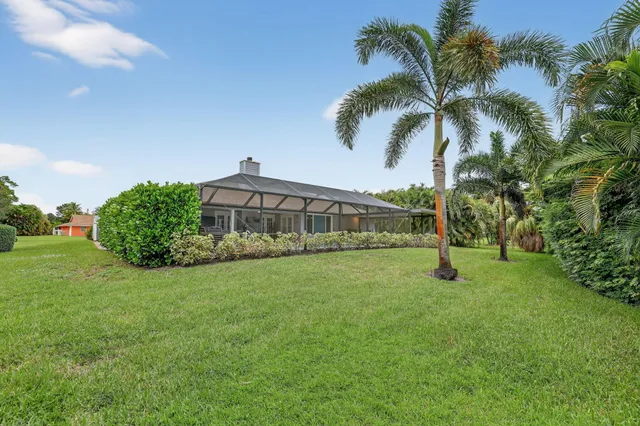 a view of a house with backyard and porch
