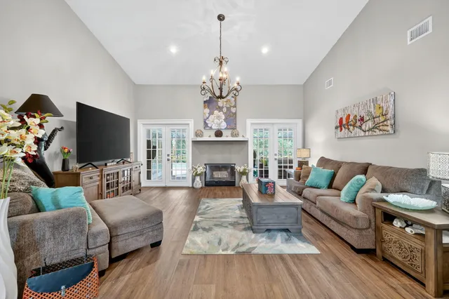 a living room with furniture a fireplace and a flat screen tv