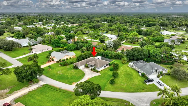a front view of a house with a yard and a garden