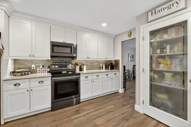 a view of a dining room with furniture and wooden floor