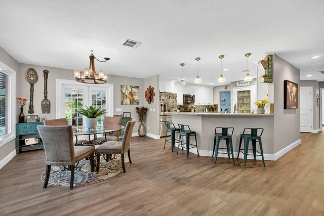 a view of a dining room with furniture window and wooden floor