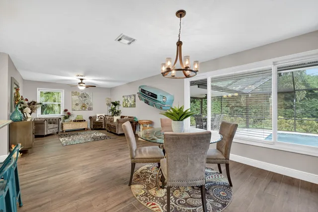 a living room with furniture ceiling fan and a rug