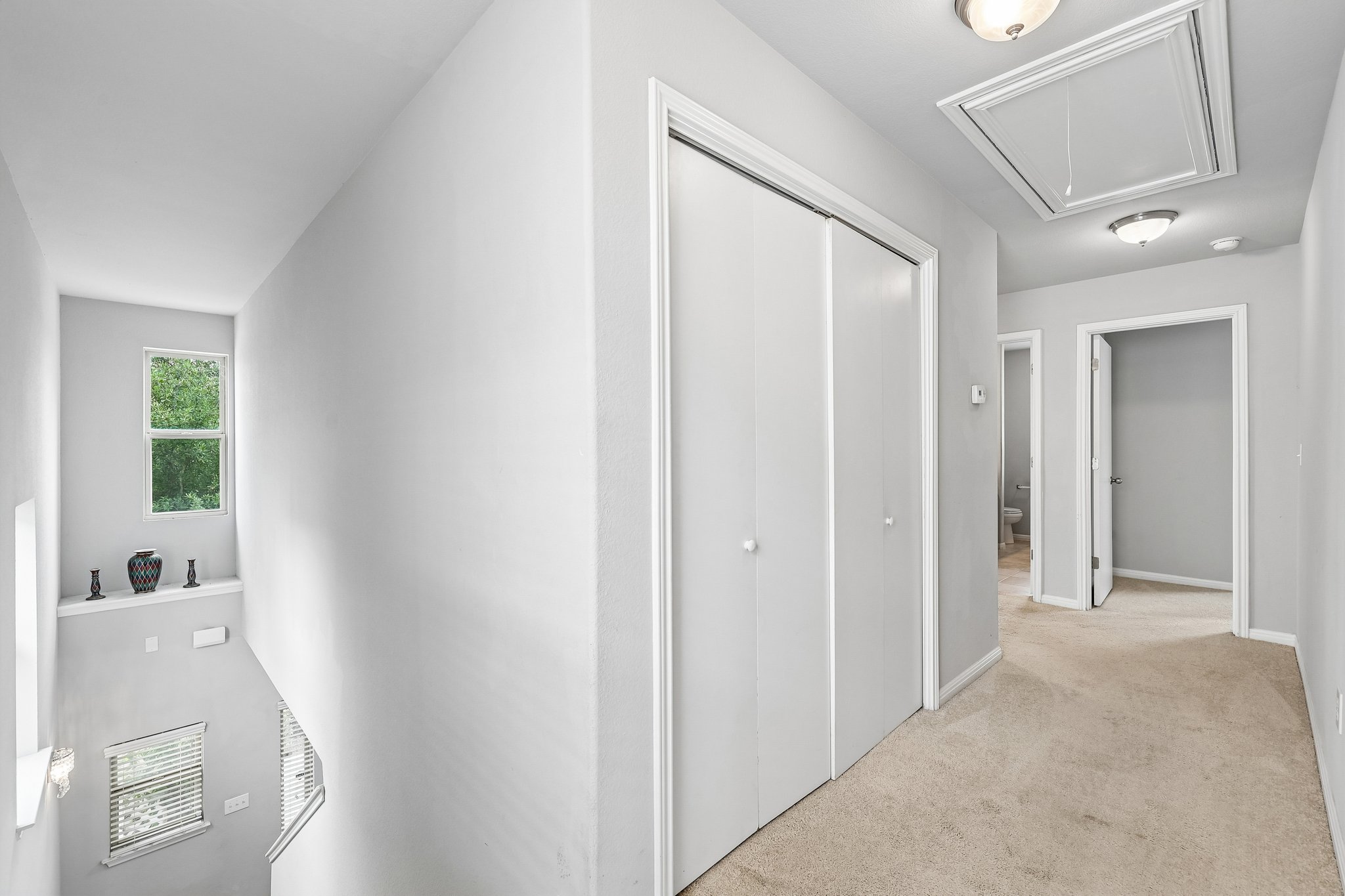 387 Guemal Road Buda, TX 78610 - Photo 18 of 39 Upper-level hallway featuring neutral carpeting, a double-door closet, and a ceiling-mounted light fixture
