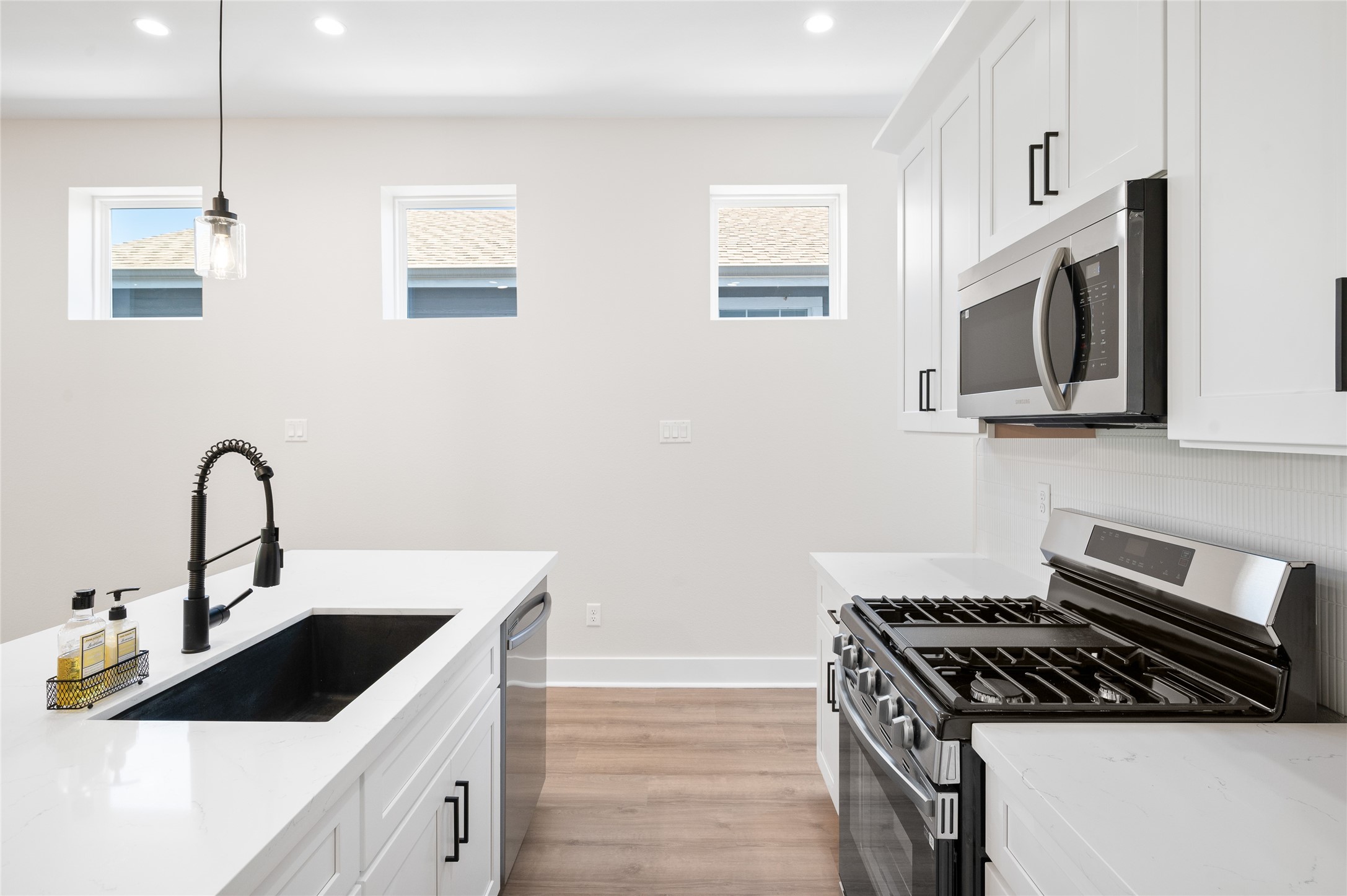 921 East 38th Street Houston, TX 77022 - Photo 13 of 40 a kitchen with stainless steel appliances granite countertop a sink stove and microwave