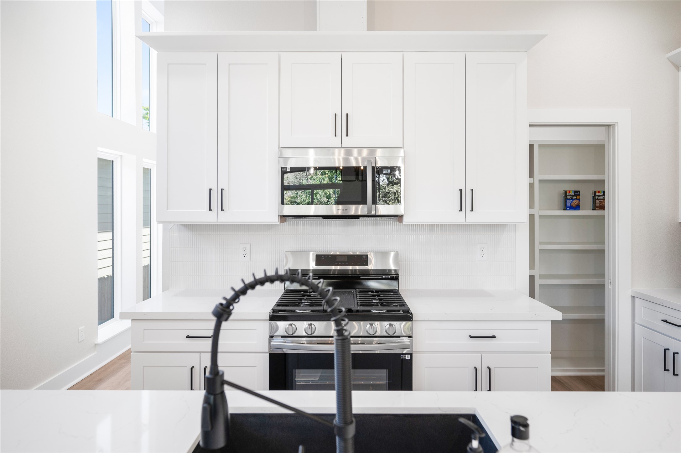 921 East 38th Street Houston, TX 77022 - Photo 21 of 40 a kitchen with stainless steel appliances granite countertop a stove and a white cabinets