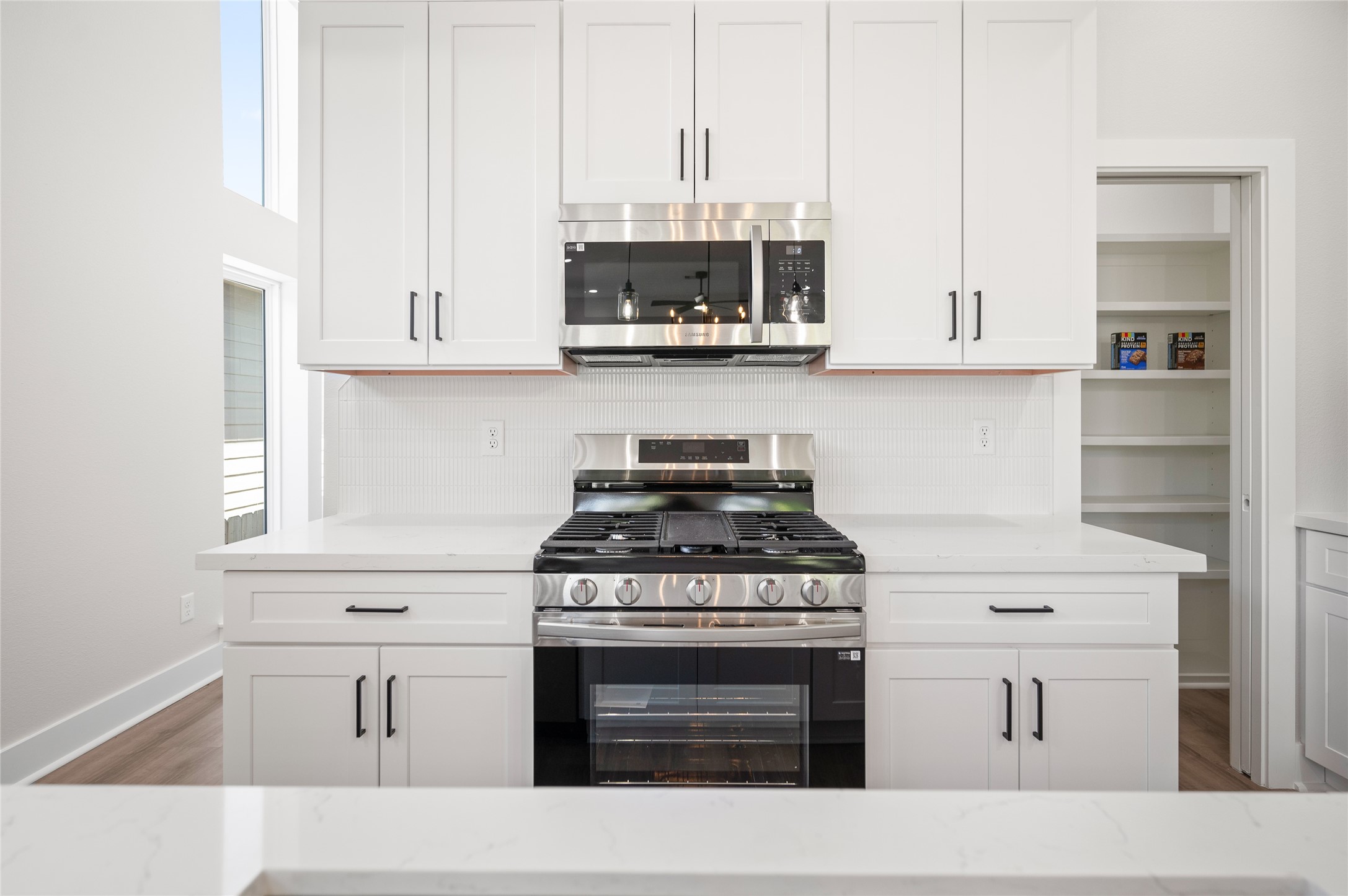 921 East 38th Street Houston, TX 77022 - Photo 22 of 40 a kitchen with stainless steel appliances white cabinets and a stove