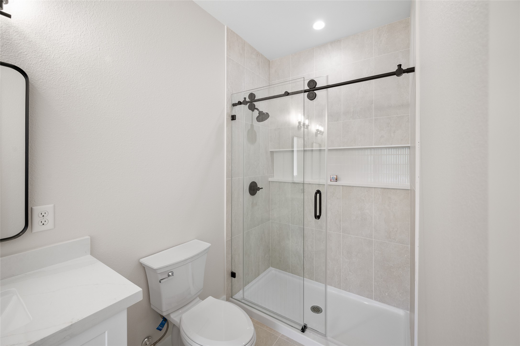 921 East 38th Street Houston, TX 77022 - Photo 29 of 40 a bathroom with a shower a toilet and sink